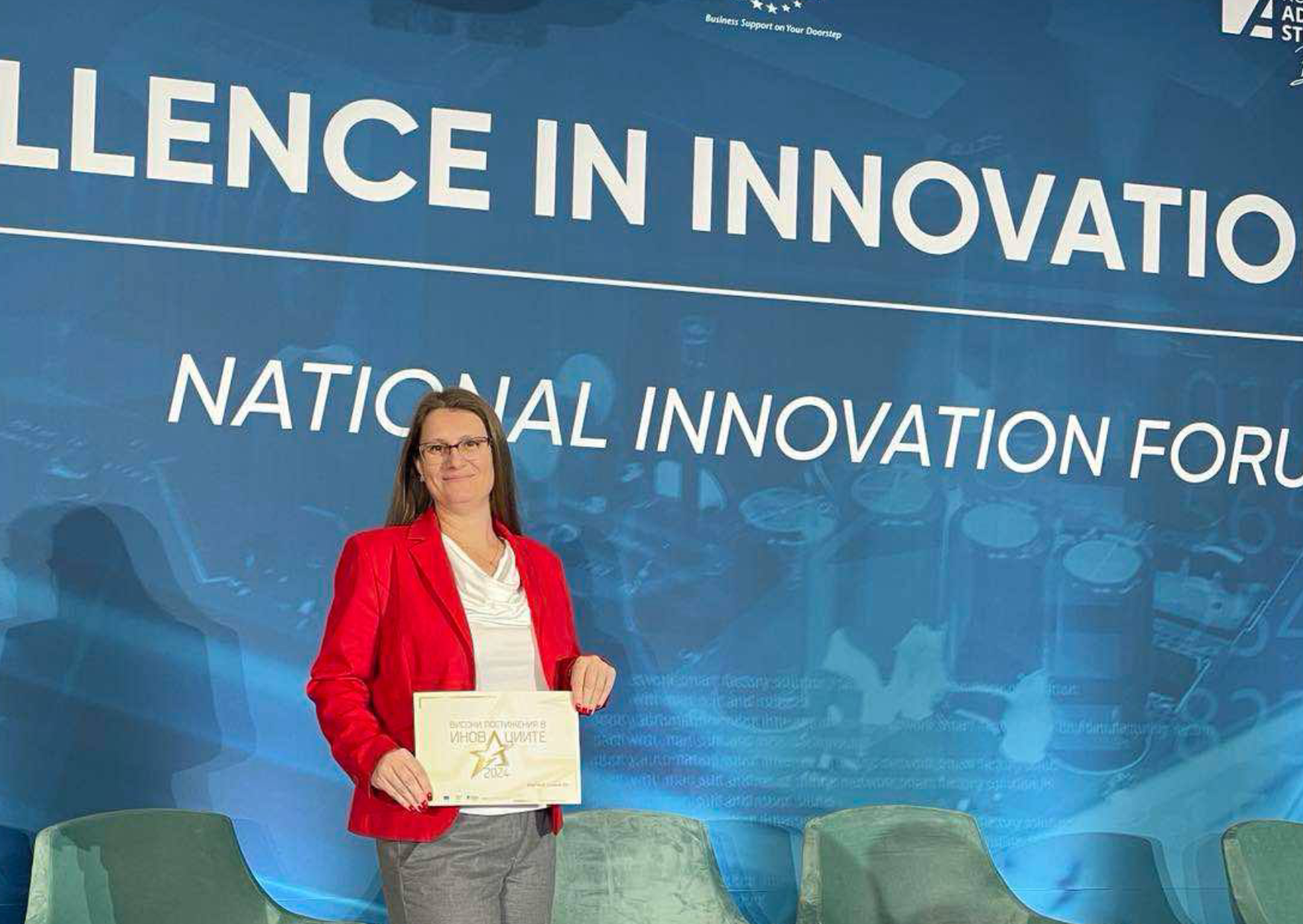 DigiTech Consult representative holding the Excellence in Innovation award certificate on stage