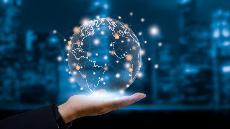 Hand holding a glowing digital globe with connected data points over a blurred blue city background.